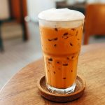 قهوه ویتنامی در لیوان شیشه ای روی میز چوبی