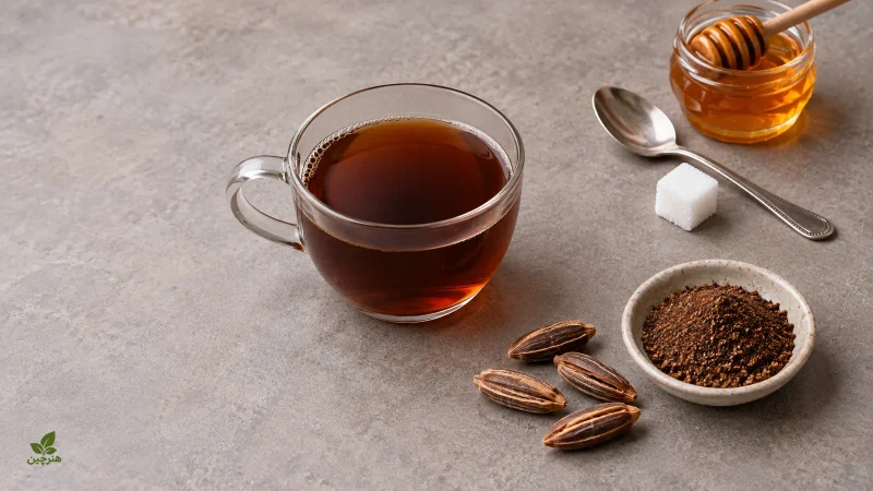 فنجان چای هسته خرما کنار عسل و حبه قند